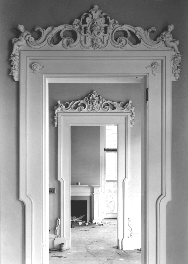 Walking down the hallway toward the front door.