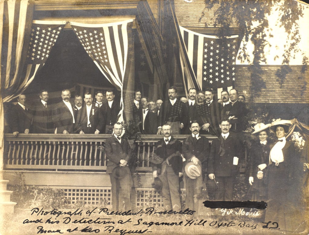 Theodore Roosevelt poses on a porch with his detectives in 1902.