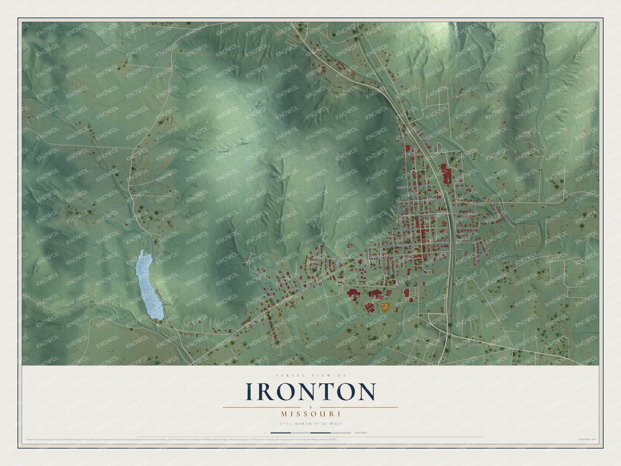 Aerial view map of Ironton, Missouri, with green shaded hills, a blue lake on the left and red buildings along the valley streets