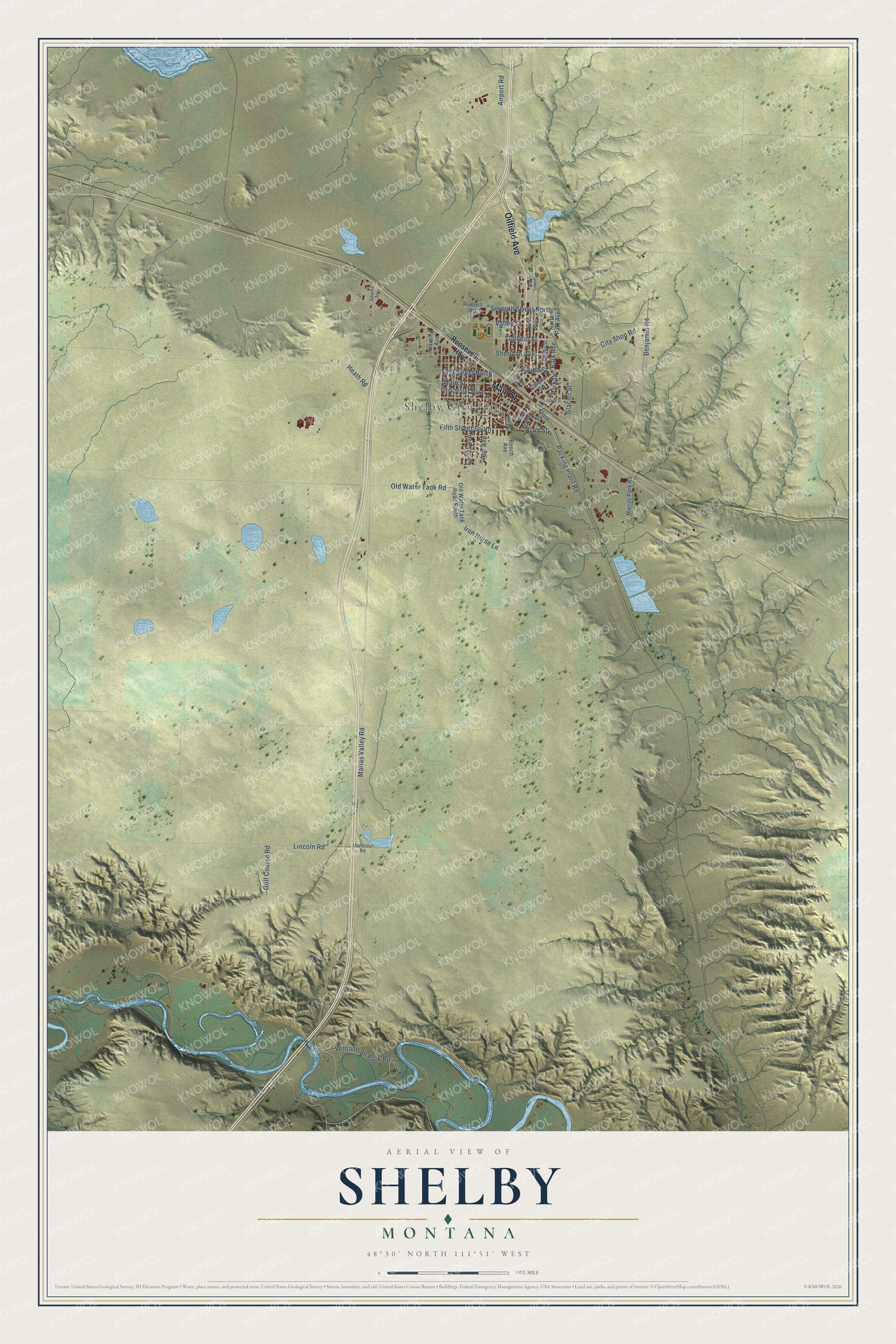 Full map of Shelby, Montana, with red buildings, printed street names and the land around them