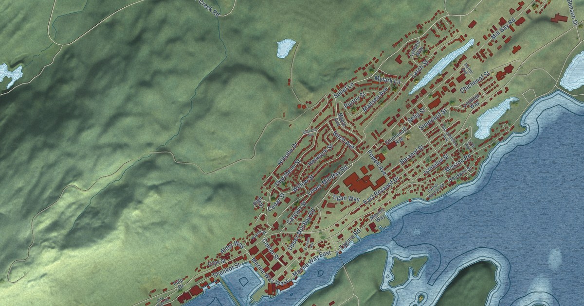 Close view of the most built-up part of Kodiak, Alaska, with rows of red buildings along its streets