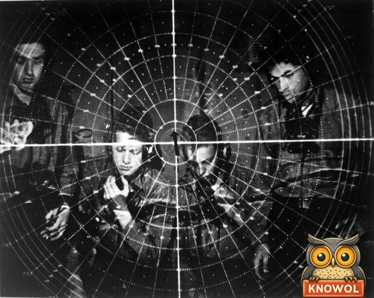 The rings and spokes of a round radar screen laid over four Navy men in headsets, two of them holding telephone handsets